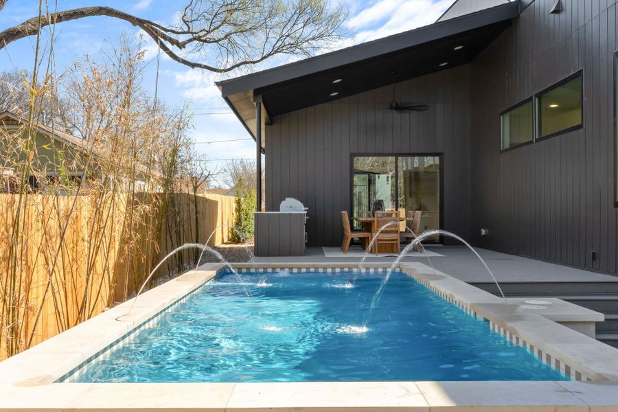 View of swimming pool featuring a fenced in pool, a patio, a ceiling fan, and fence