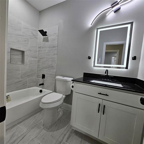Bathroom featuring vanity, and bathing tub / shower combination