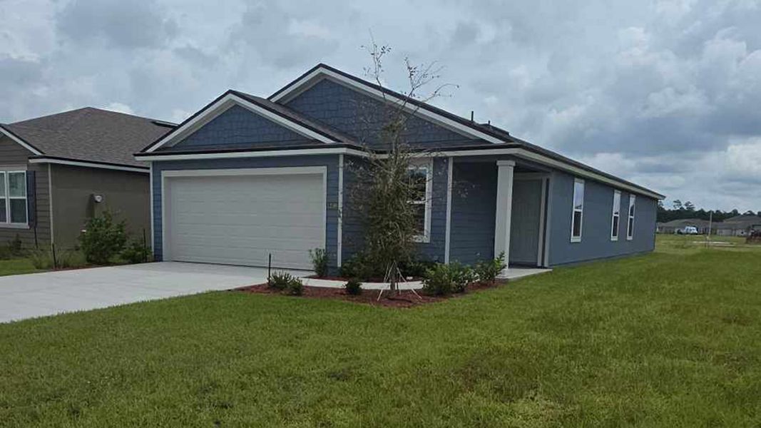 Front exterior of a new home in The Arbors, Jacksonville, FL, highlighting curb appeal (Image 2). Front exterior of a new home in The Arbors, Jacksonville, FL, highlighting curb appeal (Image 2).