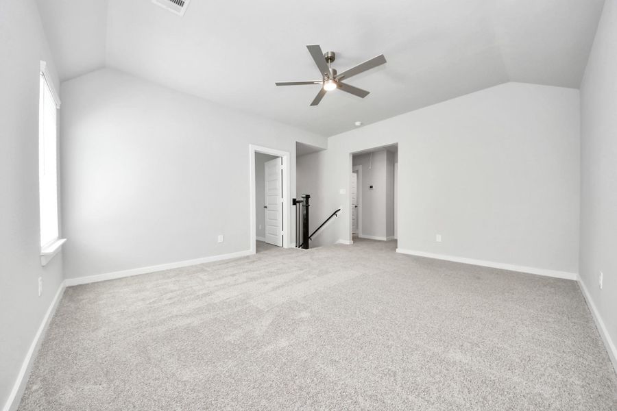 Discover a haven of leisure in this fantastic game room! Whether you're seeking a casual hangout or an adult gaming retreat, this space has it all. Enjoy the luxurious feel of plush carpet underfoot, the expansive ambiance of high ceilings, custom paint that adds a touch of personality, and windows that flood the room with refreshing natural light. Sample photo of completed home with similar floor plan. Actual colors and selections may vary. Discover a haven of leisure in this fantastic game room! Whether you're seeking a casual hangout or an adult gaming retreat, this space has it all. Enjoy the luxurious feel of plush carpet underfoot, the expansive ambiance of high ceilings, custom paint that adds a touch of personality, and windows that flood the room with refreshing natural light. Sample photo of completed home with similar floor plan. Actual colors and selections may vary.