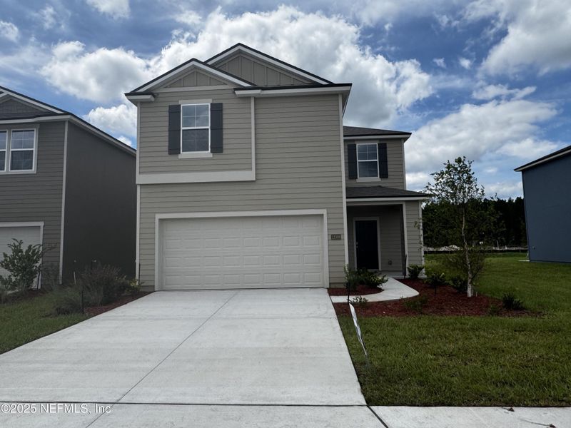 Front exterior of a new home in The Arbors, Jacksonville, FL, highlighting curb appeal (Image 28). Front exterior of a new home in The Arbors, Jacksonville, FL, highlighting curb appeal (Image 28).