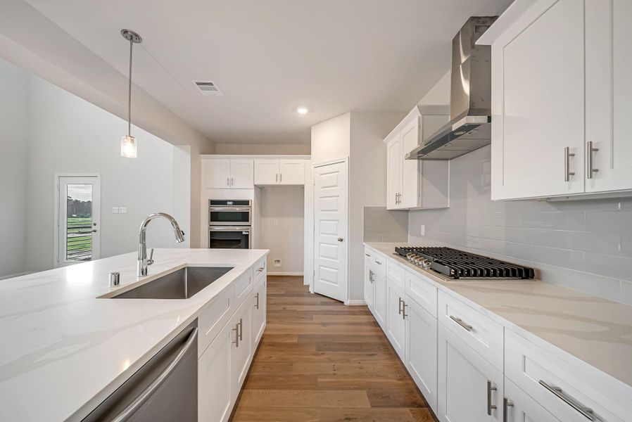 Love the undermount stainless steel farm sink and gas cooktop.