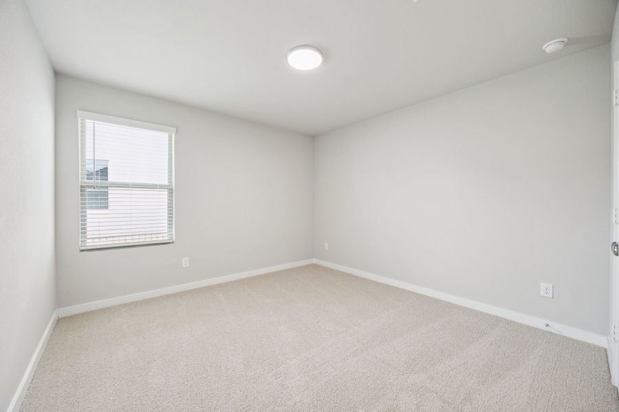 Bedroom in the Hayden home plan by Trophy Signature Homes – REPRESENTATIVE PHOTO