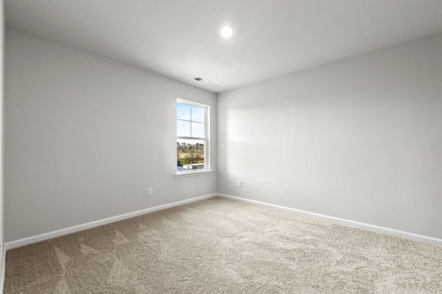A room with a window and carpet.