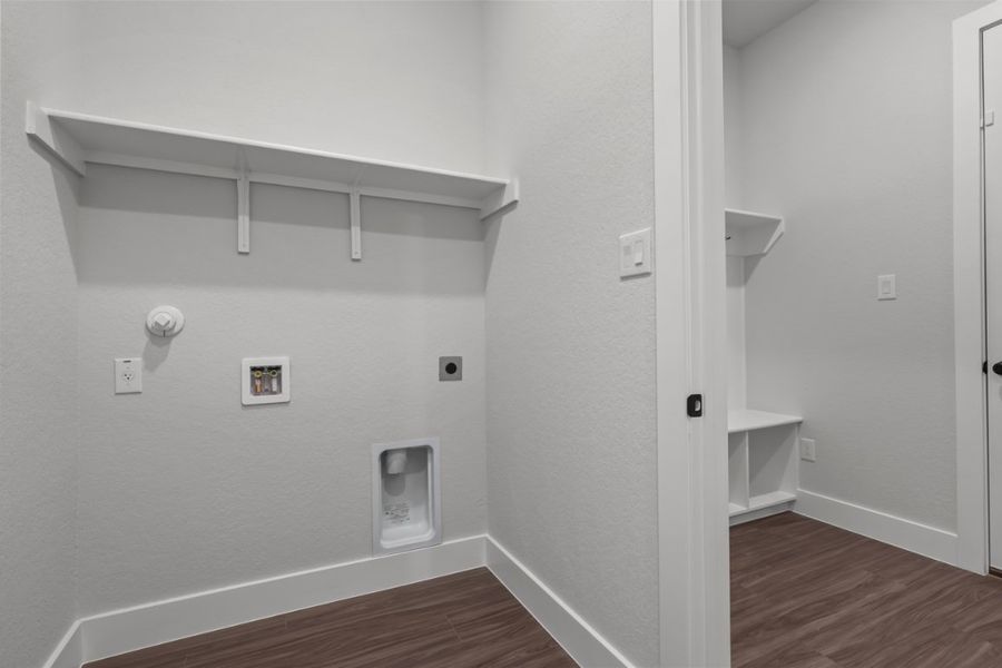 A white room with a wood floor and a white wall with a white door and a wood floor. A white room with a wood floor and a white wall with a white door and a wood floor.