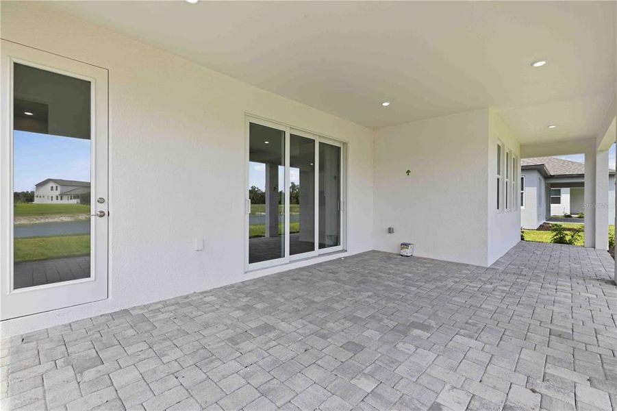 Exterior details and patio area of a home in Creeks Edge at Twin Rivers, Parrish (Image 32).
