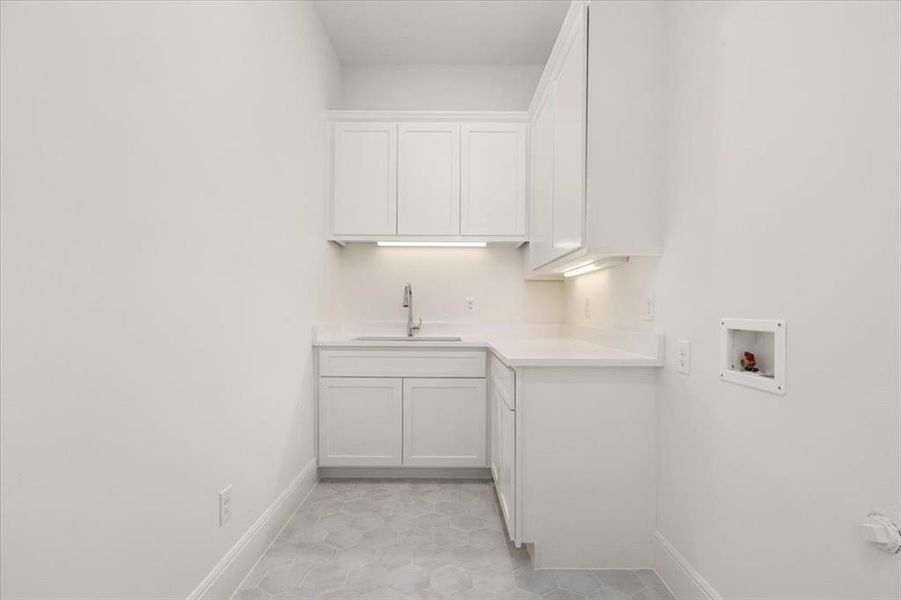 Large, tons of cabinetry for storage and a sink, near kitchen and owner's on main level