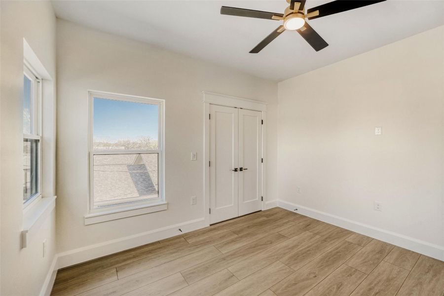 This bedroom offers corner windows for excellent natural light.