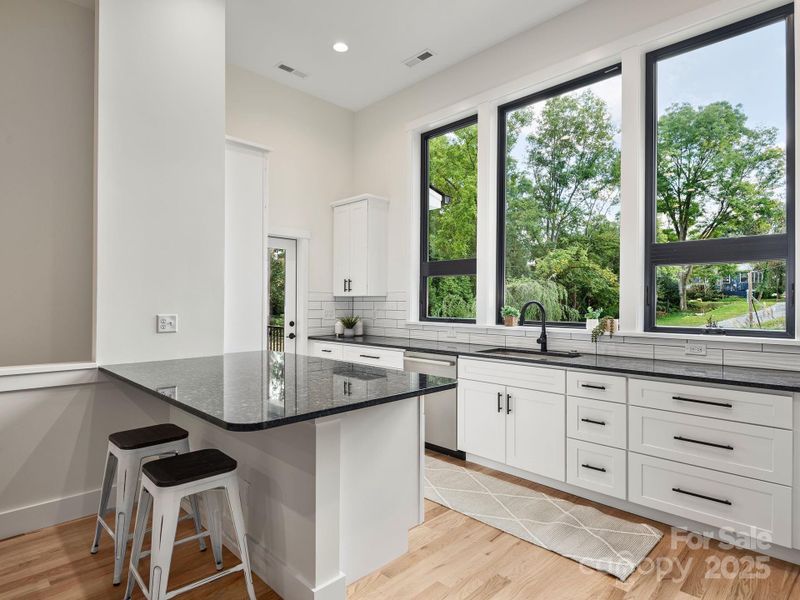 Designer kitchen with spacious countertops, breakfast bar, and stainless steel appliances