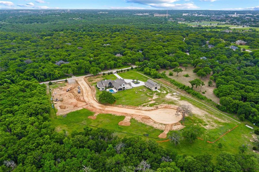 Expansive wooded acreage featuring a large single-family residence, detached auxiliary building, private swimming pool, and a partially developed cul-de-sac with an additional build site Expansive wooded acreage featuring a large single-family residence, detached auxiliary building, private swimming pool, and a partially developed cul-de-sac with an additional build site