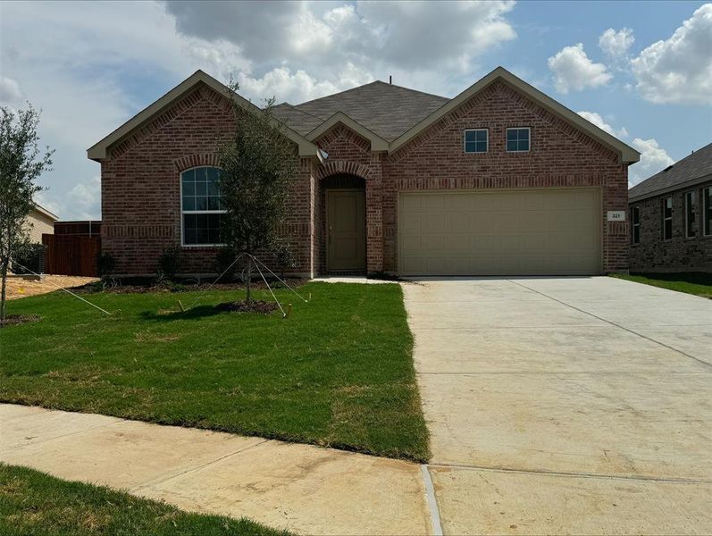 View of front of house with a garage and a front yard