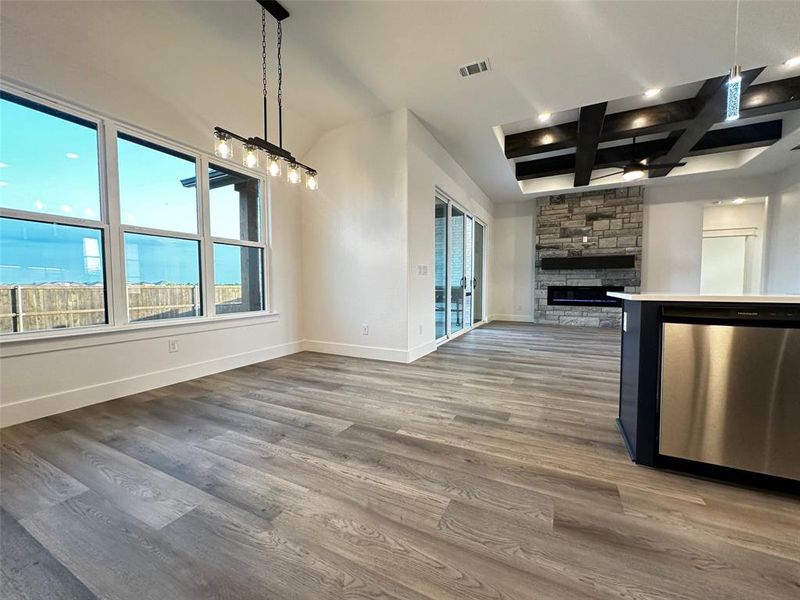 Unfurnished living room featuring baseboards, visible vents, and plenty of natural light