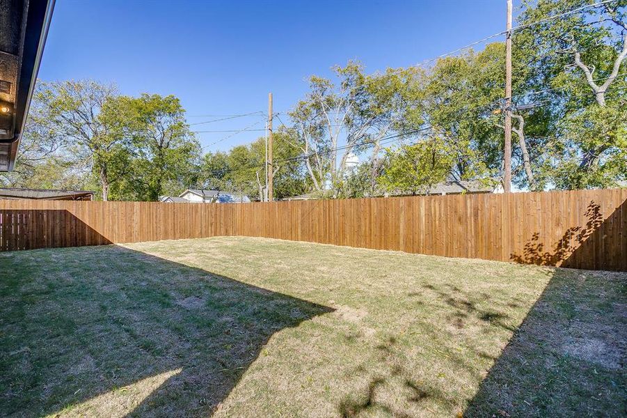 View of fenced backyard