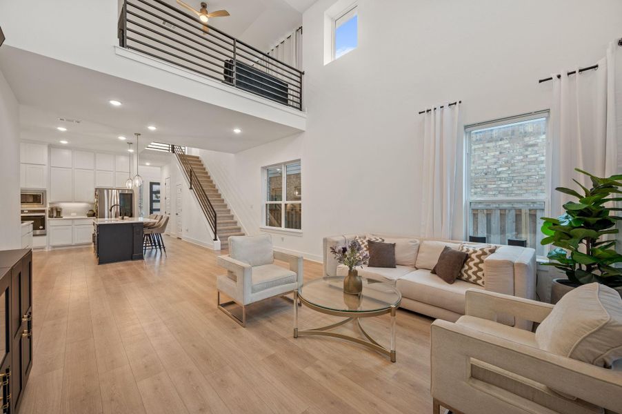 Living room with high ceilings and second story living area open to below