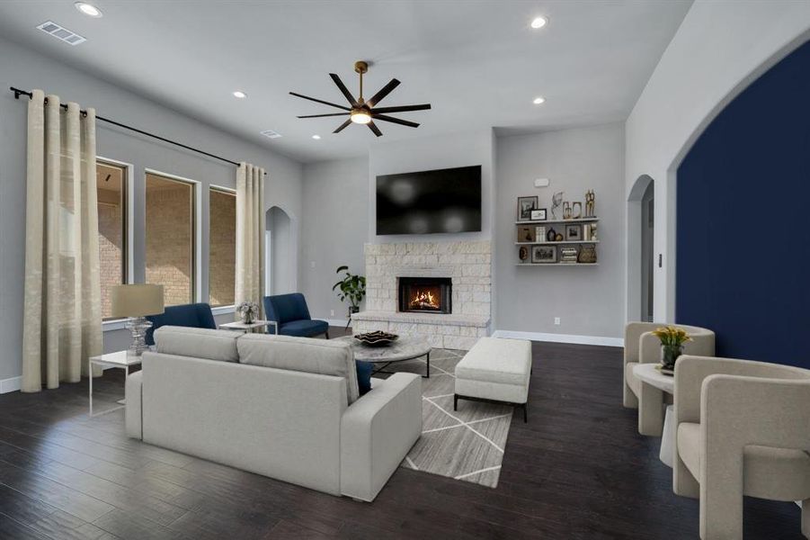 Living room featuring a fireplace, dark hardwood / wood-style flooring, and ceiling fan