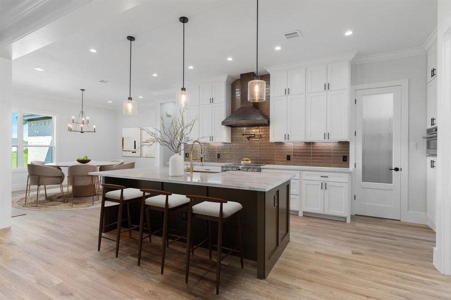 Virtual Staging - Kitchen with crown molding, decorative light fixtures, backsplash, a breakfast bar area, and white cabinets Virtual Staging - Kitchen with crown molding, decorative light fixtures, backsplash, a breakfast bar area, and white cabinets