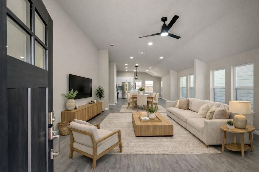 Step inside to an expansive open-concept layout featuring durable luxury tile flooring and soaring vaulted ceilings that create an airy, light-filled atmosphere.  Virtually staged