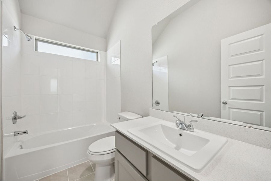 Bathroom in the Pine home plan by Trophy Signature Homes - REPRESENTATIVE PHOTO