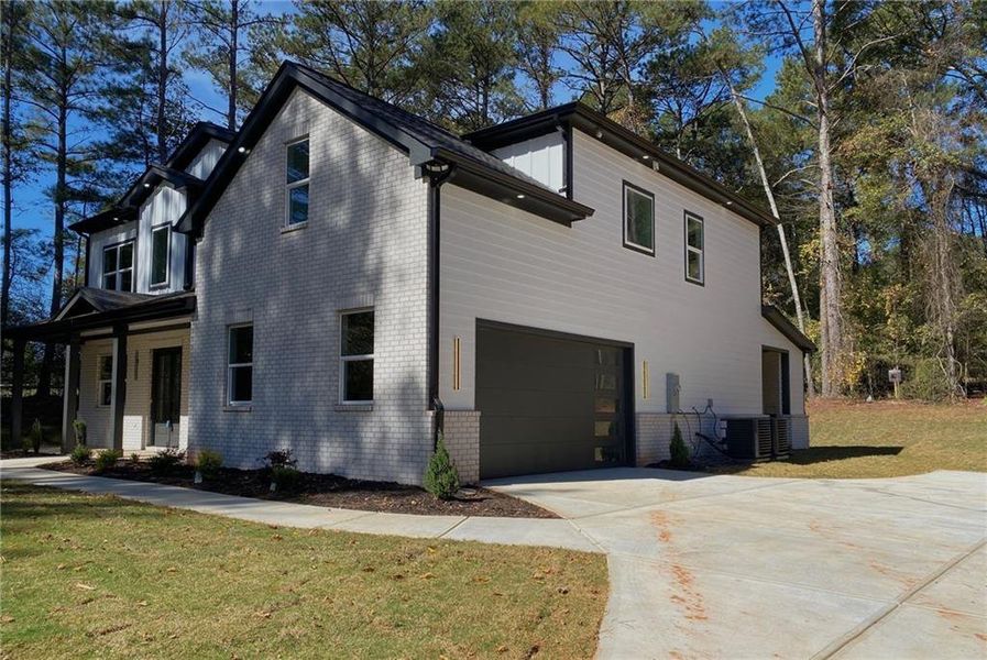 Front exterior of a new home in , Monroe, GA, highlighting curb appeal (Image 1). Front exterior of a new home in , Monroe, GA, highlighting curb appeal (Image 1).
