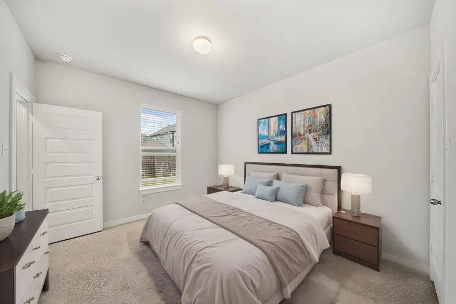 Virtually Staged: Secondary bedroom with carpet floors, a built-in closet, and a window with privacy blinds with immediate views of the backyard.
