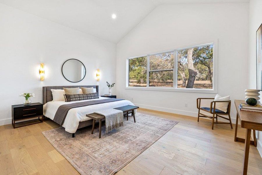 Bedroom with light wood-type flooring, recessed lighting, and high vaulted ceiling