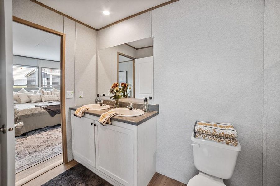 Full bathroom featuring double vanity and en-suite bathroom Full bathroom featuring double vanity and en-suite bathroom