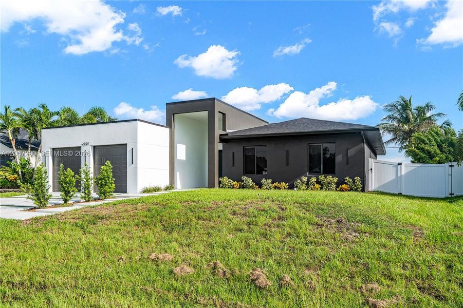 Front exterior of a new home in , Cape Coral, FL, highlighting curb appeal (Image 2). Front exterior of a new home in , Cape Coral, FL, highlighting curb appeal (Image 2).