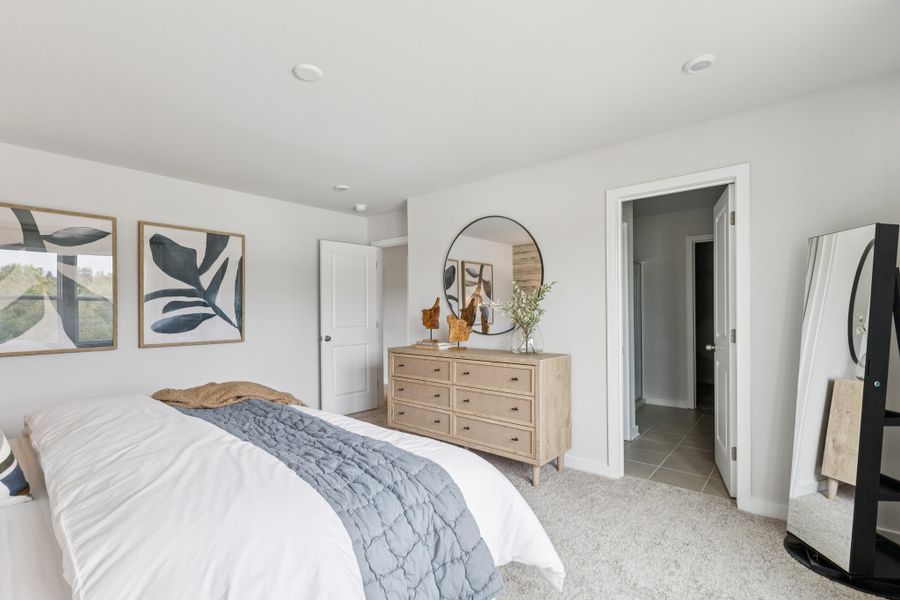 A bedroom with a bed and dresser. A bedroom with a bed and dresser.