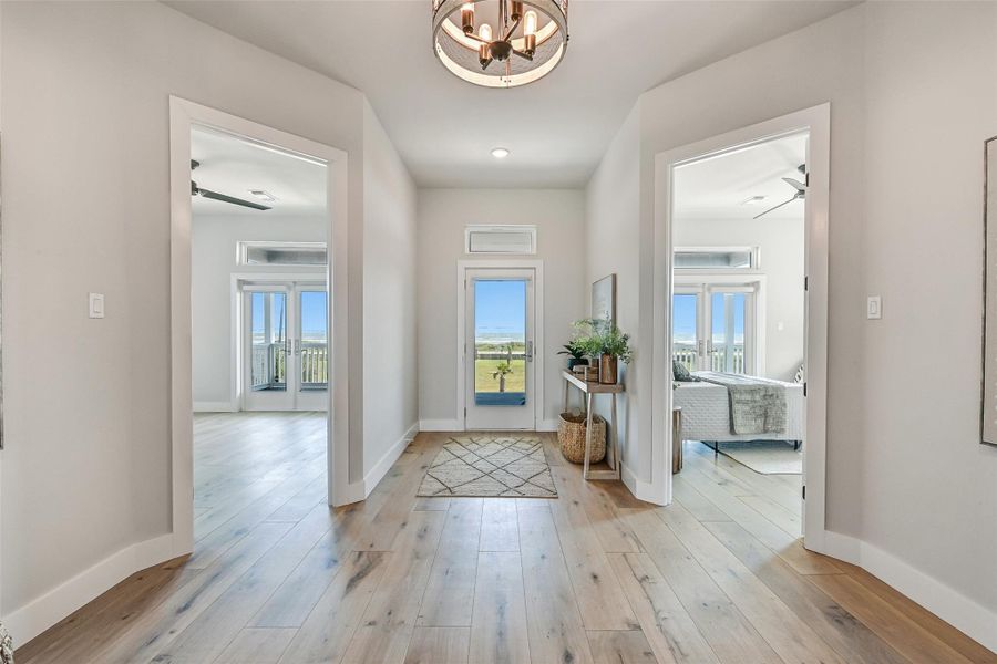This thoughtfully designed hallway enhances the open flow of the home while connecting each living space with ease. Bright interiors and clean architectural lines create a polished coastal feel.