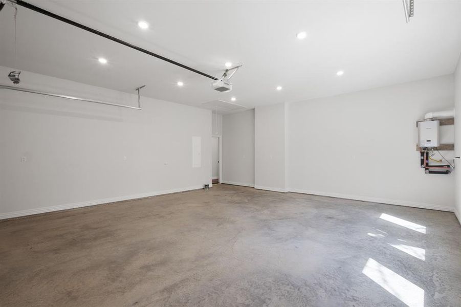 Garage with recessed lighting and tankless water heater