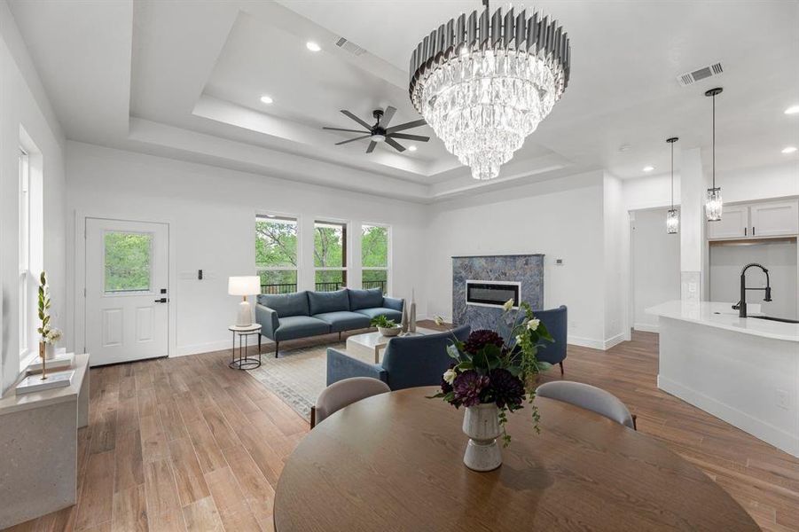 Dining space with a raised ceiling, and a beautiful fireplace