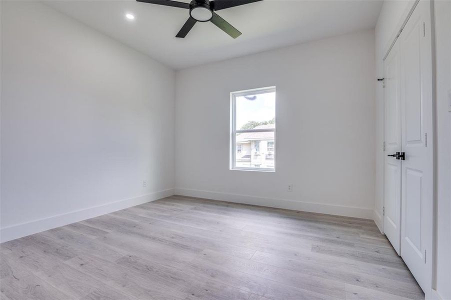 Unfurnished room with a ceiling fan, light wood-style flooring, and recessed lighting Unfurnished room with a ceiling fan, light wood-style flooring, and recessed lighting
