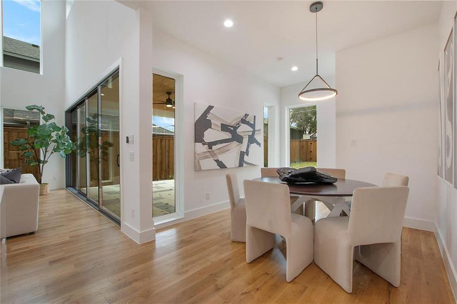 Dining space with light wood-type flooring, baseboards, recessed lighting, and a ceiling fan Dining space with light wood-type flooring, baseboards, recessed lighting, and a ceiling fan