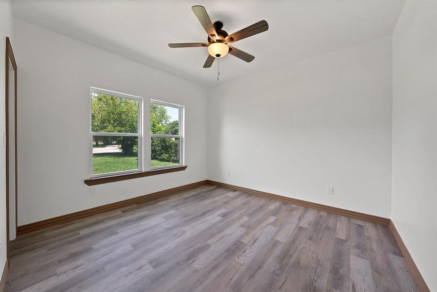 Unfurnished room featuring wood finished floors and a ceiling fan
