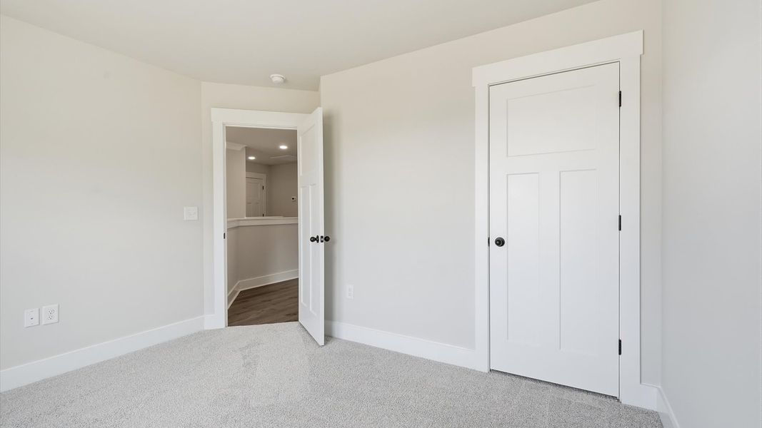 Vibrant and inviting secondary bedroom featuring a walk-in closet and refined finishes in Woodruff, SC Vibrant and inviting secondary bedroom featuring a walk-in closet and refined finishes in Woodruff, SC