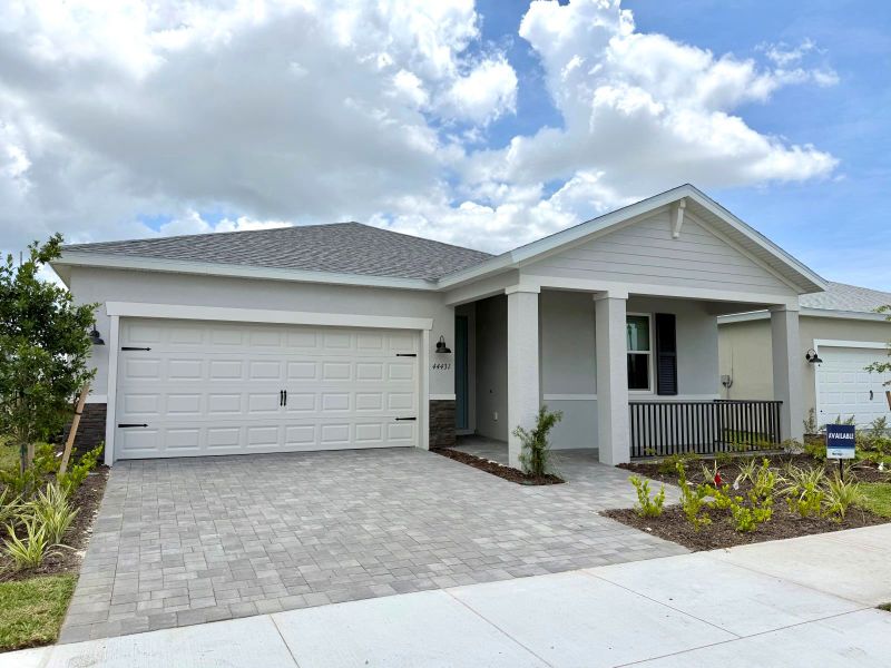 Front exterior of a new home in Crescent Lakes - Reserve Series, Punta Gorda, FL, highlighting curb appeal (Image 2). Front exterior of a new home in Crescent Lakes - Reserve Series, Punta Gorda, FL, highlighting curb appeal (Image 2).