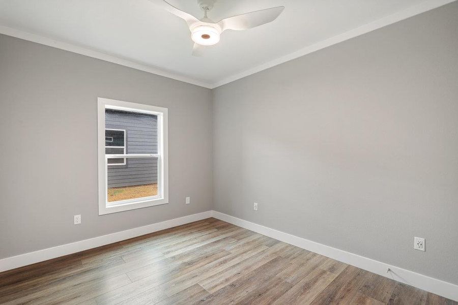 Secondary bedroom on main floor offers space for guests or a home office.  Full bathroom just outside the room.