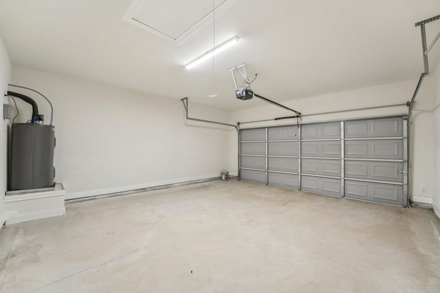 Garage with water heater and a garage door opener Garage with water heater and a garage door opener