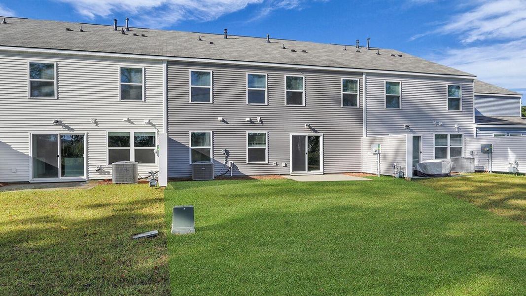 Exterior details and patio area of a home in Pine Hills Townhomes at Cane Bay, Summerville (Image 20).