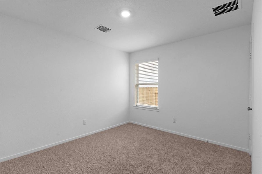 Carpeted spare room with baseboards