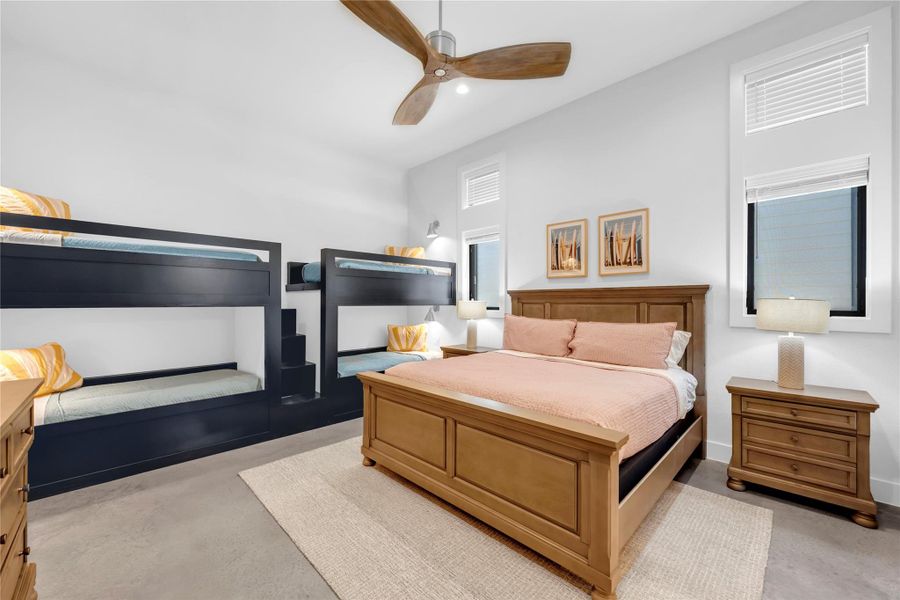 Bedroom two: High ceilings and polished concrete floors elevate this versatile, modern bedroom space.