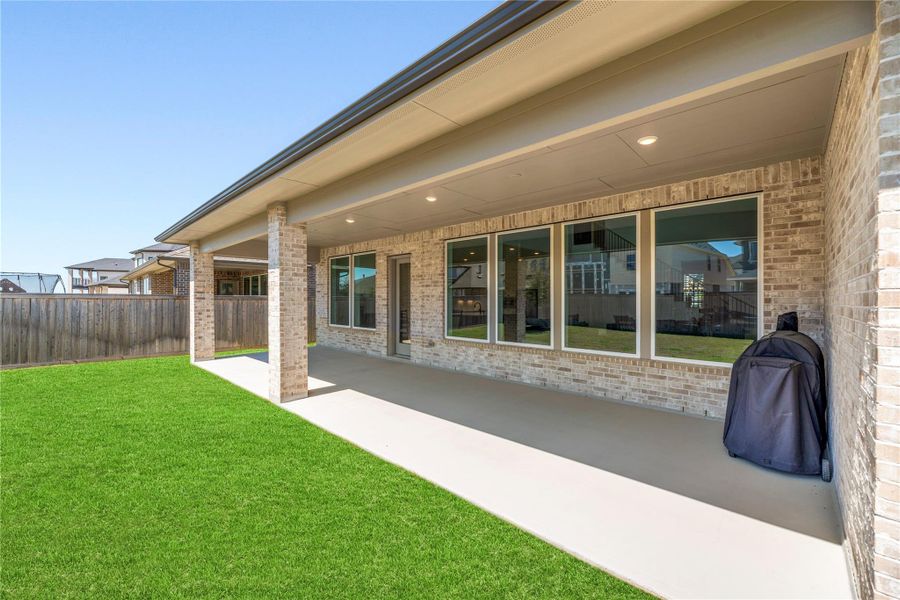Exterior details and patio area of a home in Bridgeland, Cypress (Image 26).