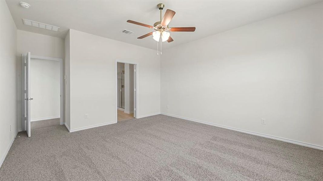 Unfurnished bedroom with light carpet and ceiling fan