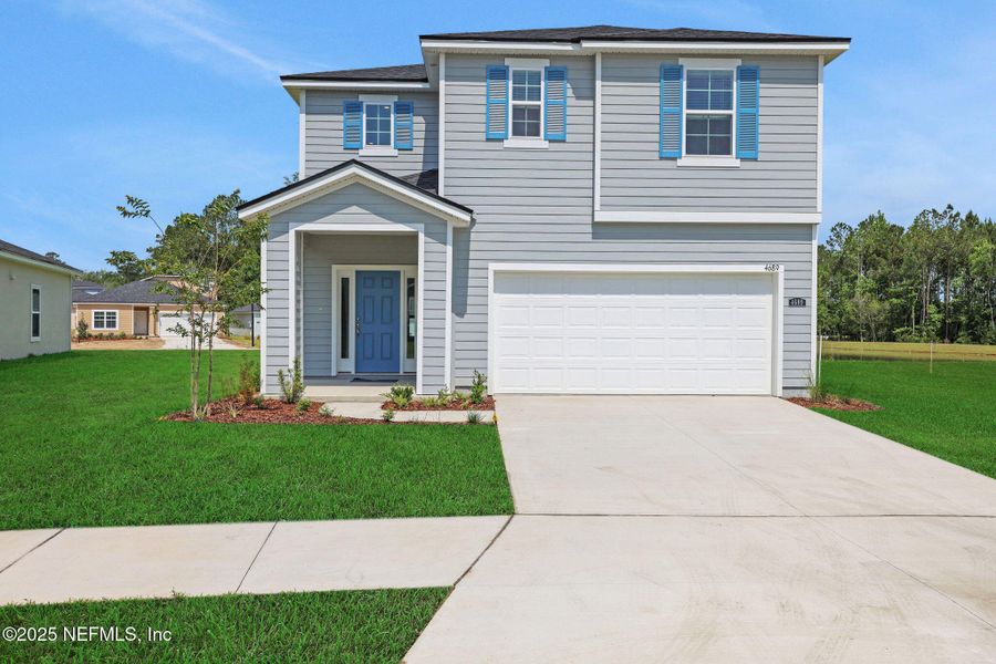 Front exterior of a new home in Amberly, Green Cove Springs, FL, highlighting curb appeal (Image 1).