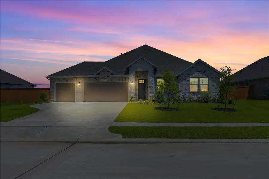 Front exterior of a new home in River Ranch Estates, Dayton, TX, highlighting curb appeal (Image 25).