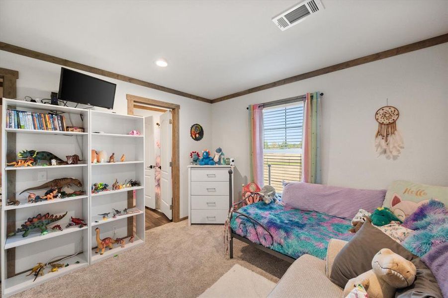 Carpeted room featuring a ceiling-mounted light fixture, recessed lighting, and a window with blinds
