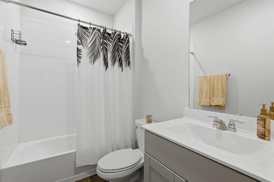 Full bath featuring shower / bath combination with curtain and vanity