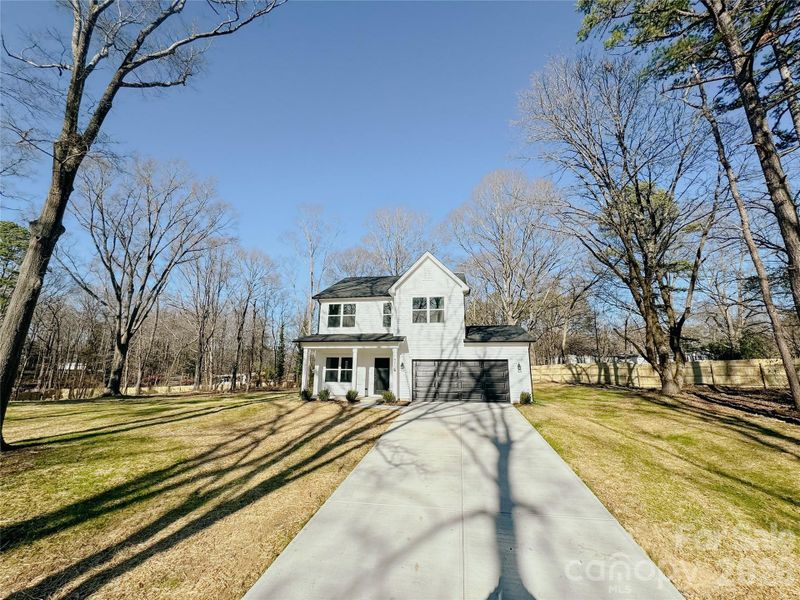 Front exterior of a new home in , Huntersville, NC, highlighting curb appeal (Image 20).