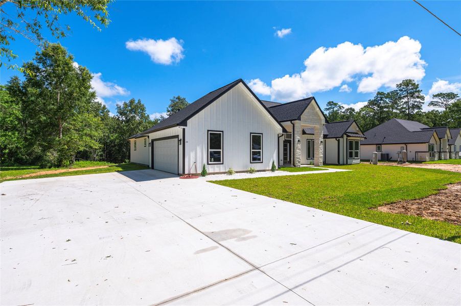 Front exterior of a new home in , Dayton, TX, highlighting curb appeal (Image 28).