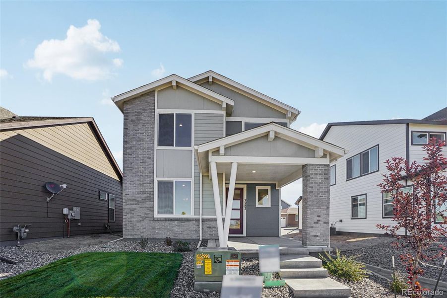 Exterior details and patio area of a home in Parkway at Prairie Center Village, Brighton (Image 27).